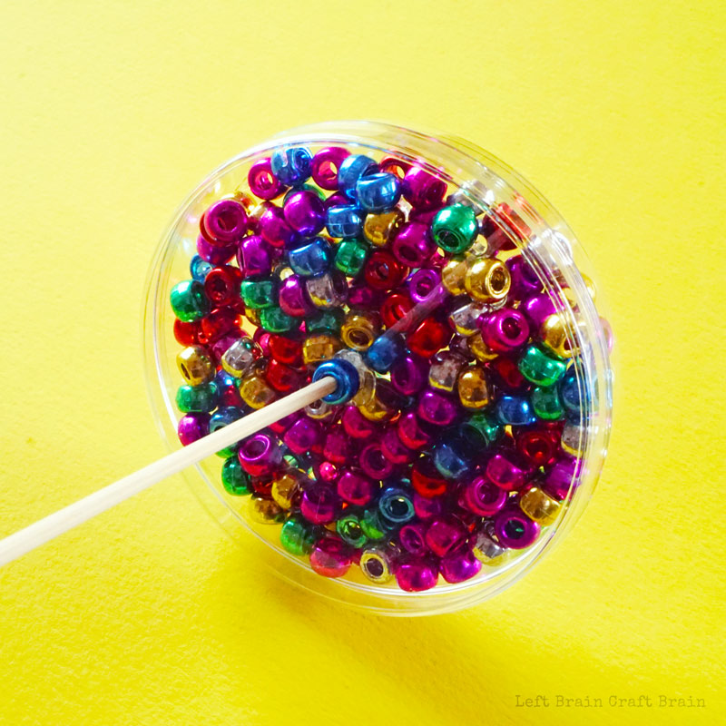 beads in petri dish with skewer.