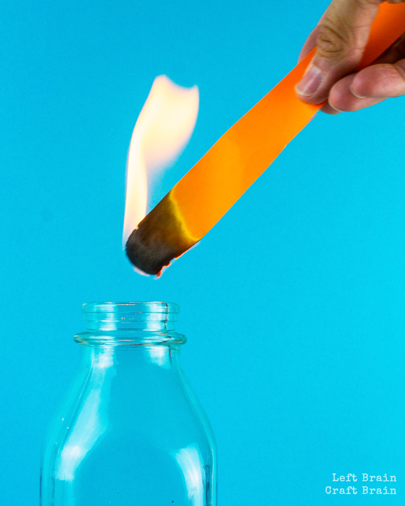 flaming paper inserting into bottle