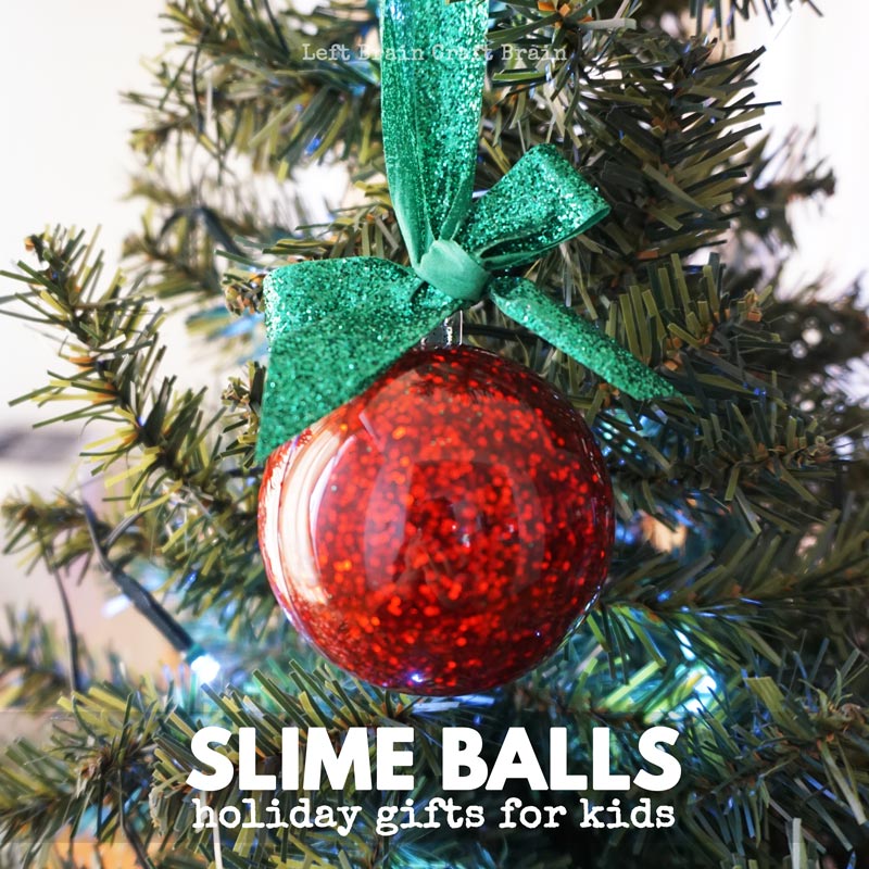 slime balls slime filled ornament hanging from ribbon on tree