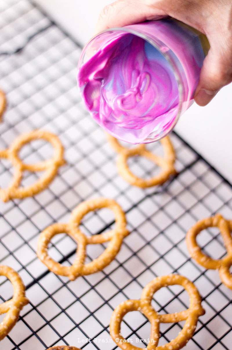 pour swirled candy melts over pretzels