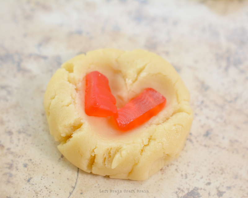 place gummy bear halves on cookie dough