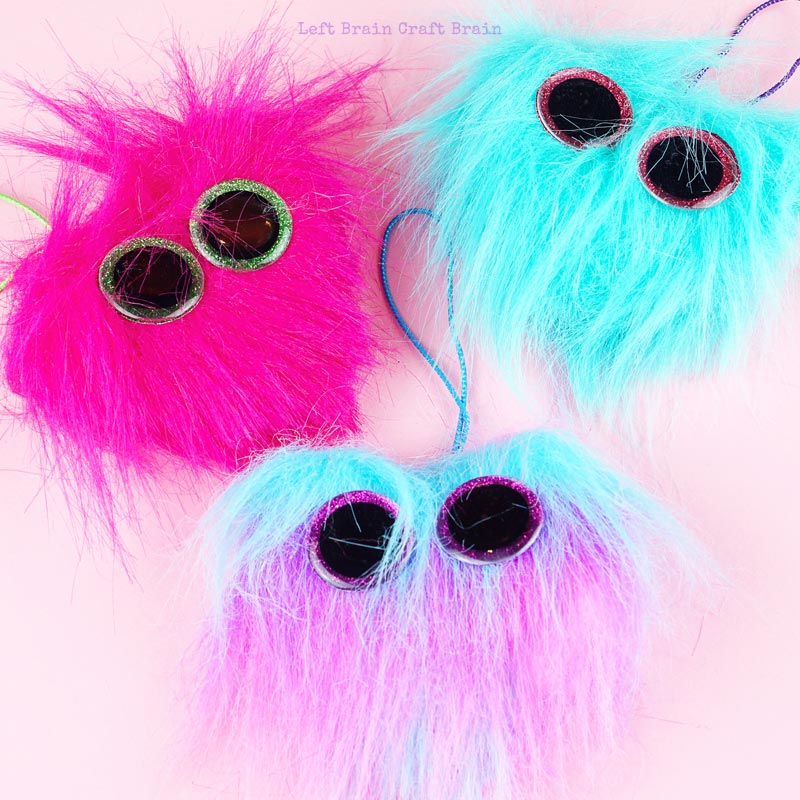 3 colors of fuzzy heart backpack charms closeup