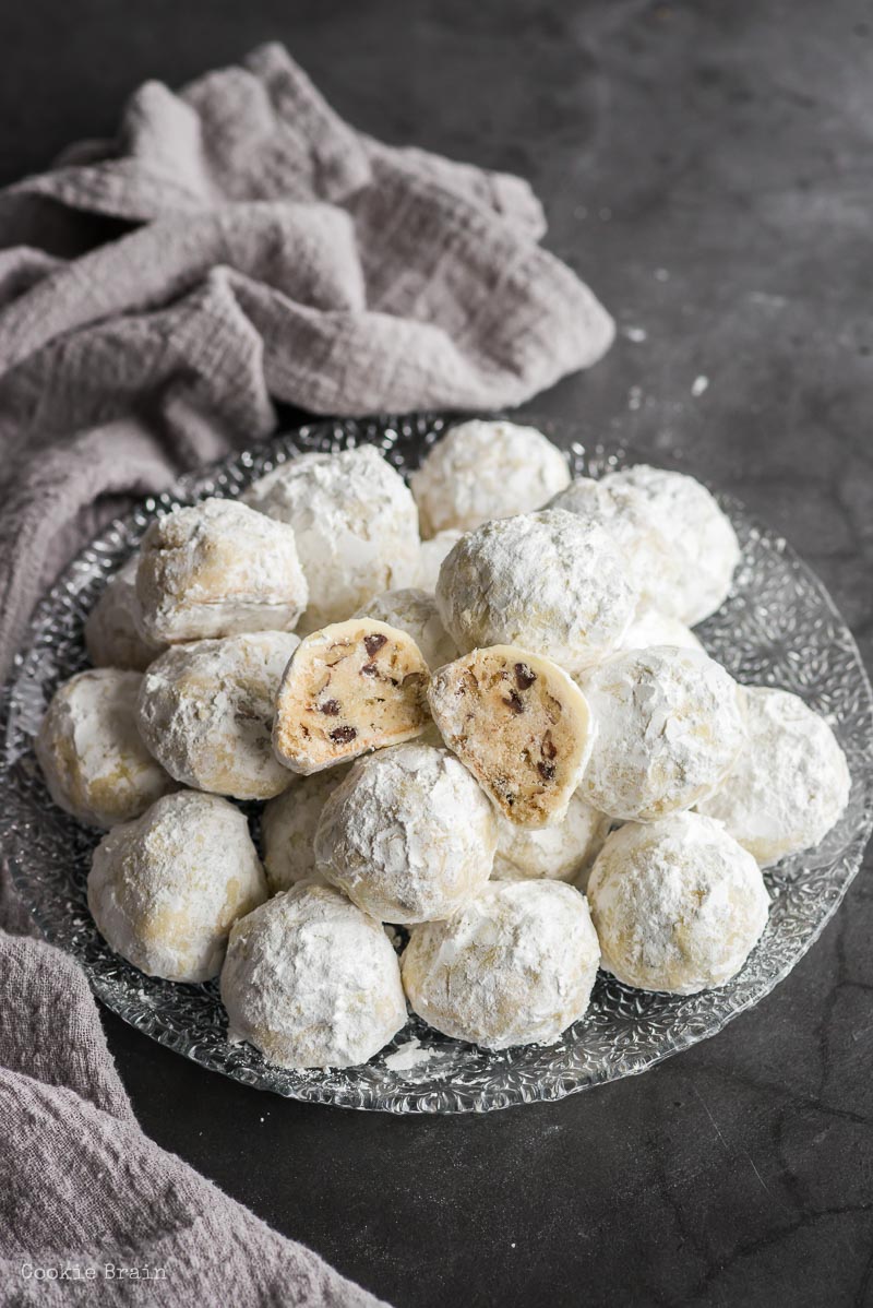 plate of snowball cookies with one broken open
