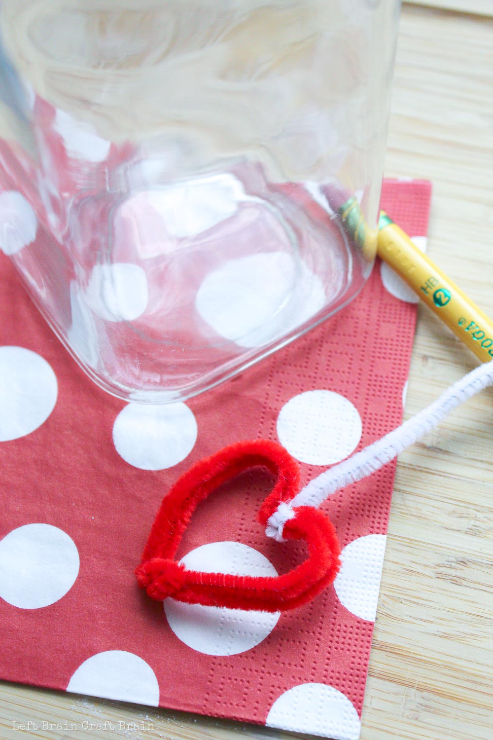Attach the pipe cleaner heart to a pencil