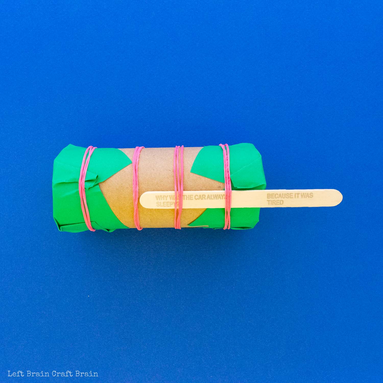 toilet paper roll maraca with paper and rubber bands and popsicle stick with jokes on blue