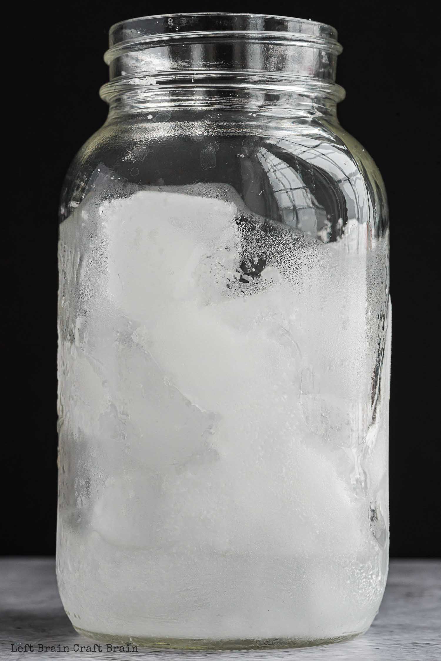 ice in jar on black background with frost on the side