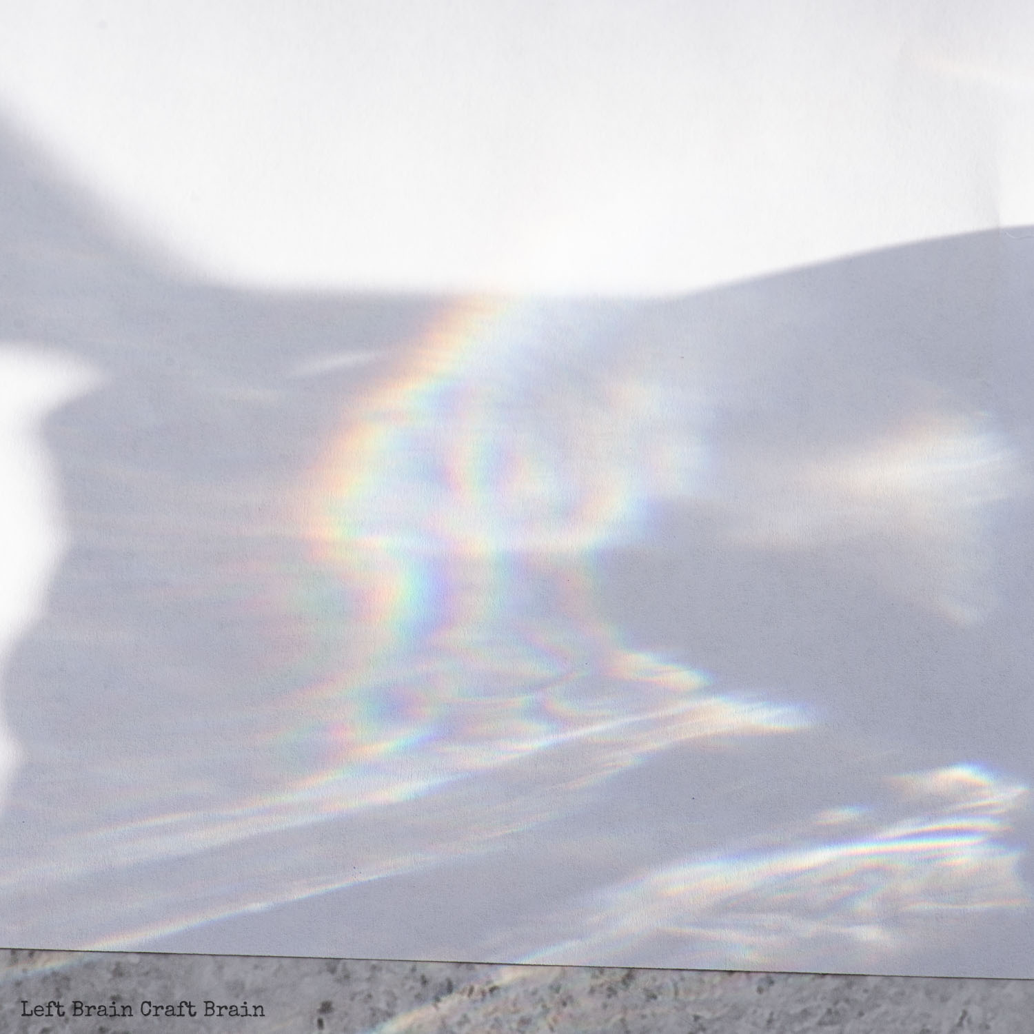 closeup of sunlight and rainbow on paper