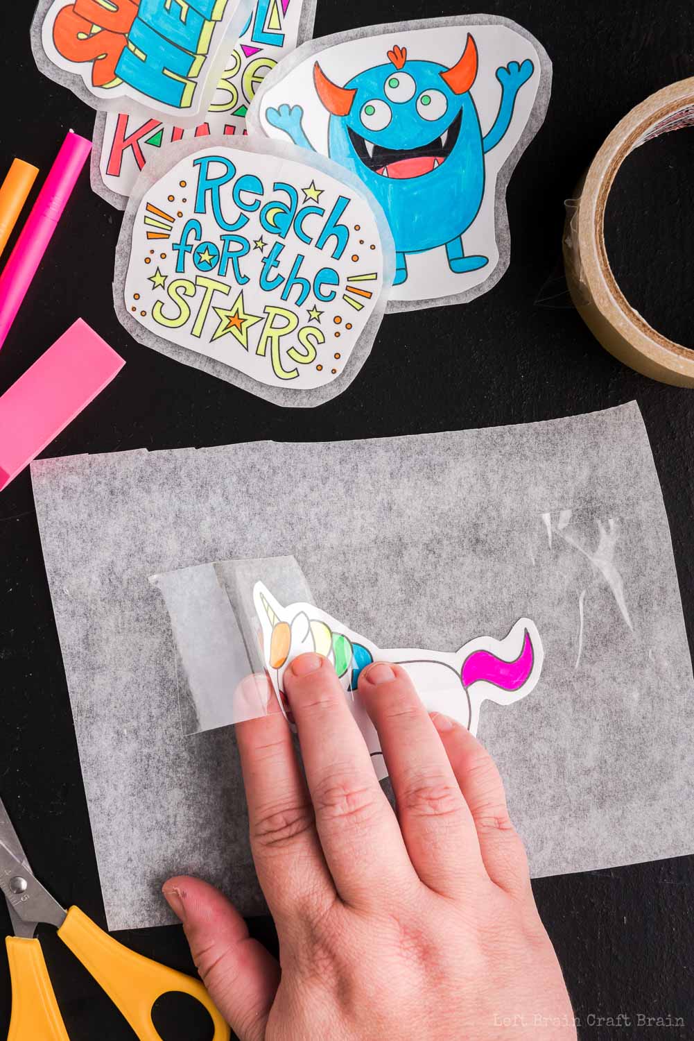 Place clear tape over design - Make your own DIY stickers with a super easy process using basic supplies. Kids will love this activity. They're fun to add to presents, too.