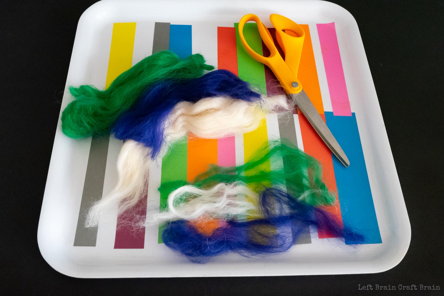 pull strands of multiple colors into long pieces to make striped felt balls